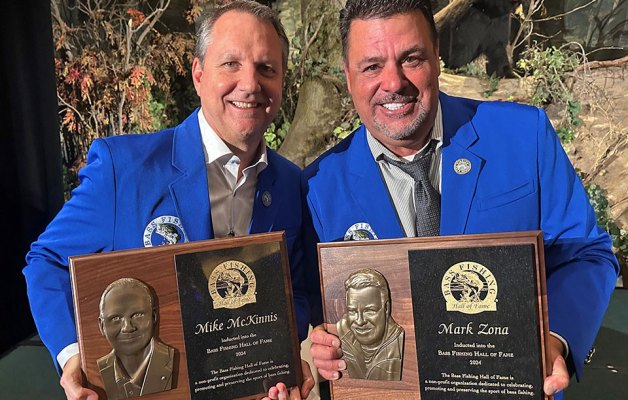 Mike McKinnis and Mark Zona pose with their Hall of Fame plaques.